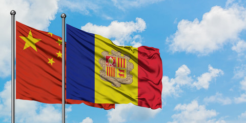 China and Andorra flag waving in the wind against white cloudy blue sky together. Diplomacy concept, international relations.