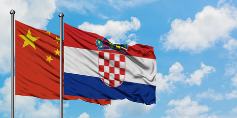 China and Croatia flag waving in the wind against white cloudy blue sky together. Diplomacy concept, international relations.