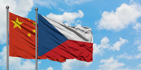 China and Czech Republic flag waving in the wind against white cloudy blue sky together. Diplomacy concept, international relations.