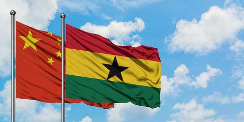 China and Ghana flag waving in the wind against white cloudy blue sky together. Diplomacy concept, international relations.