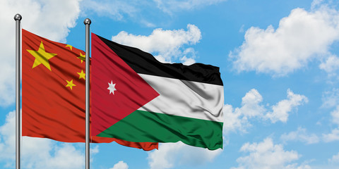 China and Jordan flag waving in the wind against white cloudy blue sky together. Diplomacy concept, international relations.