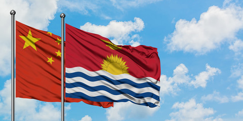 China and Kiribati flag waving in the wind against white cloudy blue sky together. Diplomacy concept, international relations.