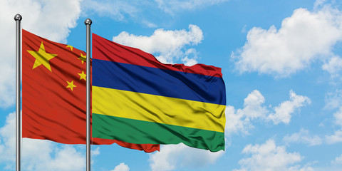 China and Mauritius flag waving in the wind against white cloudy blue sky together. Diplomacy concept, international relations.