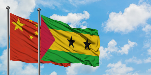 China and Sao Tome And Principe flag waving in the wind against white cloudy blue sky together. Diplomacy concept, international relations.
