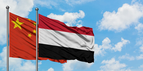 China and Yemen flag waving in the wind against white cloudy blue sky together. Diplomacy concept, international relations.