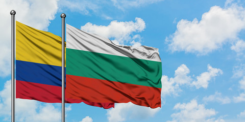 Colombia and Bulgaria flag waving in the wind against white cloudy blue sky together. Diplomacy concept, international relations.