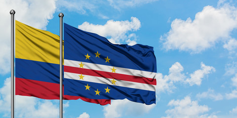 Colombia and Cape Verde flag waving in the wind against white cloudy blue sky together. Diplomacy concept, international relations.