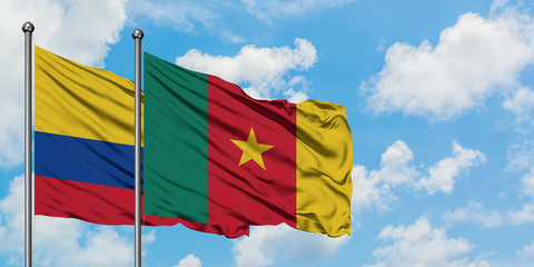 Colombia and Cameroon flag waving in the wind against white cloudy blue sky together. Diplomacy concept, international relations.