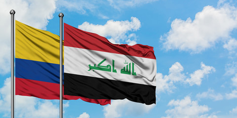 Colombia and Iraq flag waving in the wind against white cloudy blue sky together. Diplomacy concept, international relations.