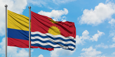 Colombia and Kiribati flag waving in the wind against white cloudy blue sky together. Diplomacy concept, international relations.