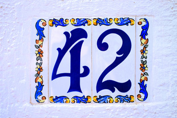 Number 42, forty-two, decorative tiles on white background.