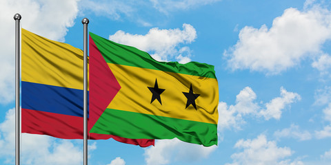 Colombia and Sao Tome And Principe flag waving in the wind against white cloudy blue sky together. Diplomacy concept, international relations.