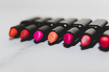 beauty industry still-life, group of colorful lipsticks lined up