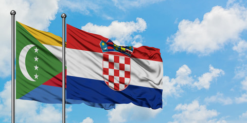 Comoros and Croatia flag waving in the wind against white cloudy blue sky together. Diplomacy concept, international relations.