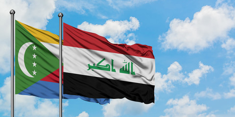 Comoros and Iraq flag waving in the wind against white cloudy blue sky together. Diplomacy concept, international relations.