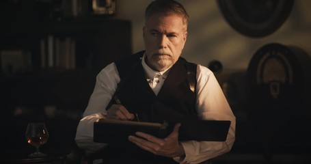 1930s gangster wearing a shoulder holster and pistol going over the ledger - Powered by Adobe