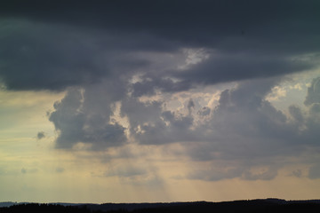 Bad weather front, thunderstorm over Upper Bavaria, storm, heavy rain and black clouds over silhouette of forest, Bavaria, Germany