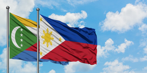 Comoros and Philippines flag waving in the wind against white cloudy blue sky together. Diplomacy concept, international relations.