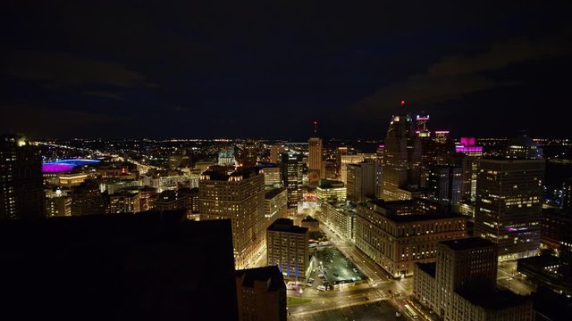 Detroit Michigan Aerial v146 Flying through downtown cityscape panning around toward river at night - October 2017
