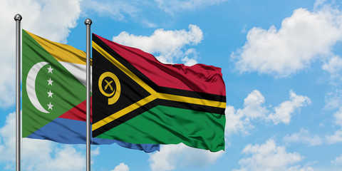 Comoros and Vanuatu flag waving in the wind against white cloudy blue sky together. Diplomacy concept, international relations.