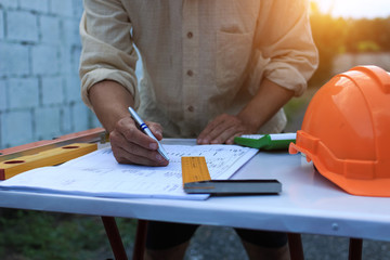 Architectural work site desk background construction project ideas concept, With drawing equipmen