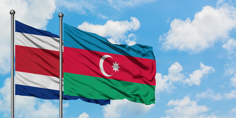 Costa Rica and Azerbaijan flag waving in the wind against white cloudy blue sky together. Diplomacy concept, international relations.