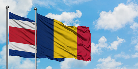 Costa Rica and Chad flag waving in the wind against white cloudy blue sky together. Diplomacy concept, international relations.