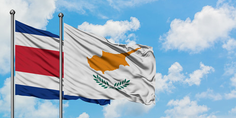 Costa Rica and Cyprus flag waving in the wind against white cloudy blue sky together. Diplomacy concept, international relations.