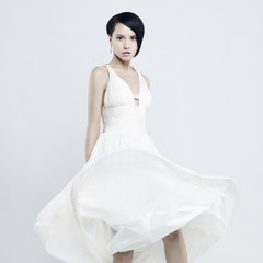 Beautiful young lady in a billowing white dress