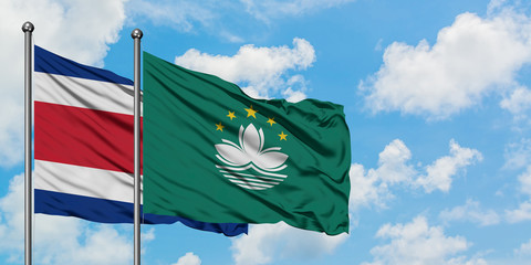 Costa Rica and Macao flag waving in the wind against white cloudy blue sky together. Diplomacy concept, international relations.