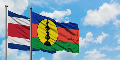 Costa Rica and New Caledonia flag waving in the wind against white cloudy blue sky together. Diplomacy concept, international relations.