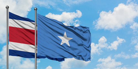 Costa Rica and Somalia flag waving in the wind against white cloudy blue sky together. Diplomacy concept, international relations.