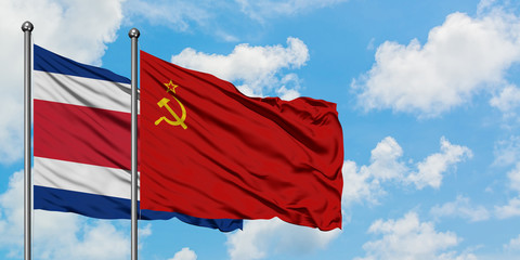 Costa Rica and Soviet Union flag waving in the wind against white cloudy blue sky together. Diplomacy concept, international relations.