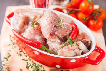 pieces of meat of chicken with tomatoes and pepper in a bowl on a table, selective focus, copy space