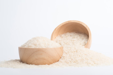 Fototapeta na wymiar Clean rice grain in a brown wooden bowl on a white background.