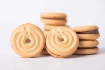 Obraz na płótnie Canvas Cookies stuffed with coffee cream stacked on a white background.