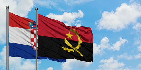 Croatia and Angola flag waving in the wind against white cloudy blue sky together. Diplomacy concept, international relations.