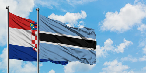 Croatia and Botswana flag waving in the wind against white cloudy blue sky together. Diplomacy concept, international relations.