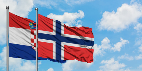 Croatia and Bouvet Islands flag waving in the wind against white cloudy blue sky together. Diplomacy concept, international relations.