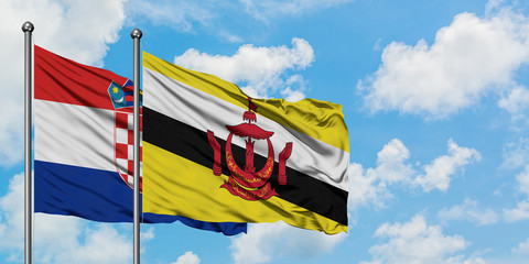 Croatia and Brunei flag waving in the wind against white cloudy blue sky together. Diplomacy concept, international relations.