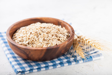 Oat flakes in a bowl on a table, selective focus, copy space