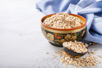 Oat flakes in a bowl on a table, selective focus, copy space