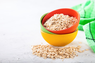 Oat flakes in a bowl on a table, selective focus, copy space