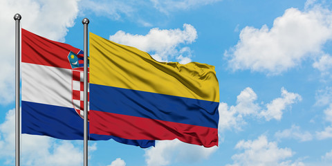 Croatia and Colombia flag waving in the wind against white cloudy blue sky together. Diplomacy concept, international relations.
