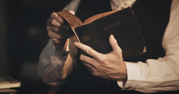 closeup of a man in the 1930s man reading the bible