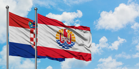 Croatia and French Polynesia flag waving in the wind against white cloudy blue sky together. Diplomacy concept, international relations.