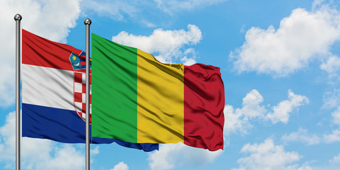Croatia and Mali flag waving in the wind against white cloudy blue sky together. Diplomacy concept, international relations.