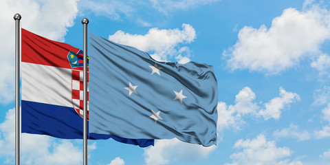 Croatia and Micronesia flag waving in the wind against white cloudy blue sky together. Diplomacy concept, international relations.