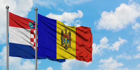 Croatia and Moldova flag waving in the wind against white cloudy blue sky together. Diplomacy concept, international relations.