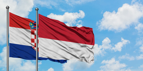 Croatia and Monaco flag waving in the wind against white cloudy blue sky together. Diplomacy concept, international relations.